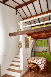 a dining room with a table and a staircase in a house at Borgo S.Maria Di Vulci in Montalto di Castro