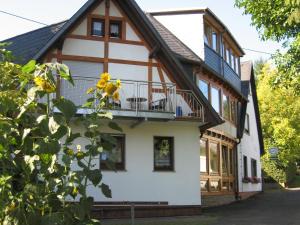 a house with a balcony on the side of it at Pension Haus Ursula in Koblenz