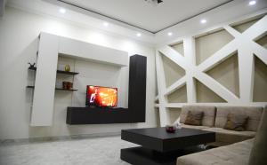 a living room with a couch and a tv at Metekhi Vista in Tbilisi City