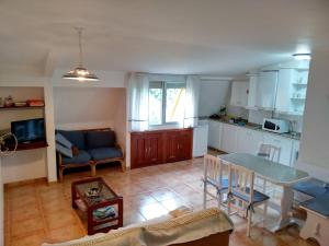 a kitchen and a living room with a table and chairs at Pilar Villanueva in Bueu