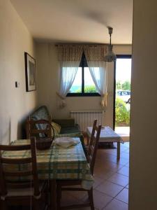 a living room with a table and a couch at Pilar Villanueva in Bueu