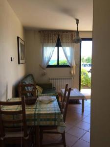 a living room with a table and a couch at Pilar Villanueva in Bueu +28 photos