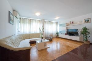 a living room with a couch and a tv at Apartment Vilea in Split
