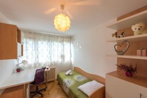 a room with a bed and a desk and a window at Apartment Vilea in Split
