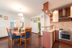 a kitchen and dining room with a table and chairs at Apartment Vilea in Split