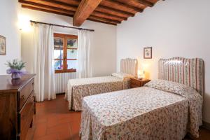 Postel nebo postele na pokoji v ubytování Agriturismo Fattoria di Sommaia