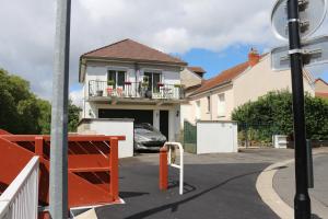 a house with a car parked in front of it at La Sichonnette in Vichy