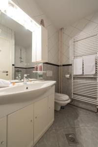 a bathroom with a sink and a toilet and a mirror at Apartment Vilea in Split +28 photos