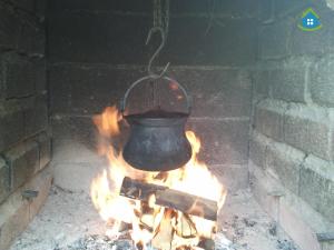 a pot over a fire in a brick oven at Guest House VEZ Bihac in Bihać