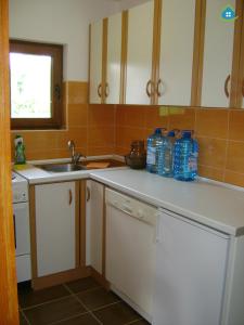 a kitchen with a sink and bottles of water on the counter at Guest House VEZ Bihac in Bihać