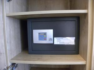 a small television on a shelf in a room at City Hotel in Luxembourg