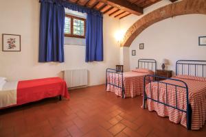 Postel nebo postele na pokoji v ubytování Agriturismo Fattoria di Sommaia