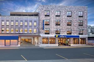 a large brick building with a store front at Scholar Morgantown, Tapestry Collection by Hilton in Morgantown