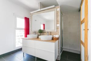 a bathroom with two sinks and a mirror at Luxury Penthouse in Naturiste; FKK, Nudist Village in Cap d'Agde