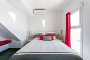 a bedroom with a large bed with red pillows at Luxury Penthouse in Naturiste; FKK, Nudist Village in Cap d'Agde