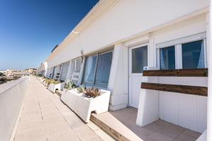 a row of windows on a building with plants at Luxury Penthouse in Naturiste; FKK, Nudist Village in Cap d'Agde