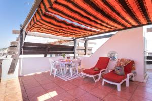 a patio with a table and chairs on a balcony at Luxury Penthouse in Naturiste; FKK, Nudist Village in Cap d'Agde