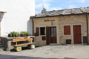 a building with a wooden bench in front of it at b&b casamia in Molina
