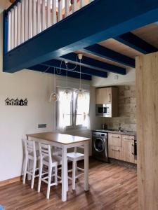 a kitchen with a table and chairs in a room at Playas de Luarca in Barcia