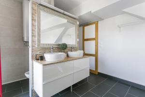 a bathroom with two sinks and a mirror at Luxury Penthouse in Naturiste; FKK, Nudist Village in Cap d'Agde +25 photos