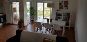 a living room with a white table and chairs at Monte Clérigo - Aljezur - Apartamento T2 in Aljezur