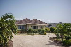 a house with palm trees and a driveway at Jamaica Shades @ Cool Shades in Priory