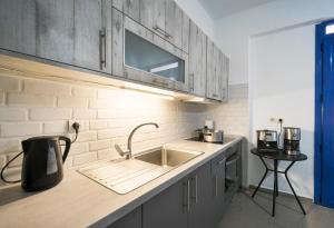 a kitchen with a sink and a counter top at Sunset Home Crete in Paránimfoi