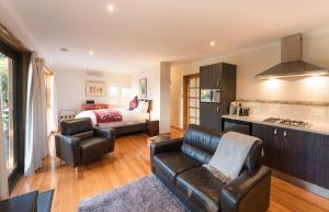a kitchen and living room with a couch and a bed at Parnella Kettering in Kettering