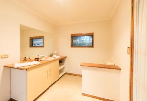 a bathroom with a sink and a mirror at Parnella Kettering in Kettering