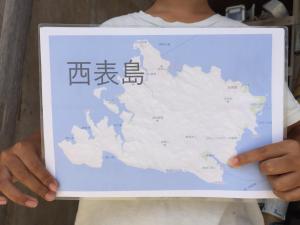 a person holding a map in their hands at Shimaotoya in Iriomote