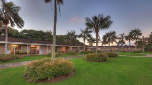 a resort with palm trees and a building at Daydreamer Apartments in Burnt Pine