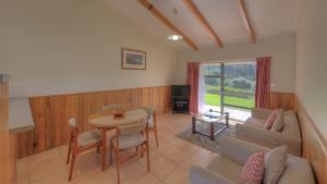 a living room with a table and a couch at Daydreamer Apartments in Burnt Pine