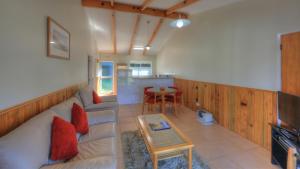 a living room with a couch and a table at Daydreamer Apartments in Burnt Pine