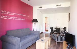 a living room with a couch and a table at MH Apartments Suites in Barcelona +15 photos