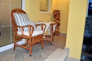 two wicker chairs and a table on a porch at Boutique Villa Amalia in Chernomorets