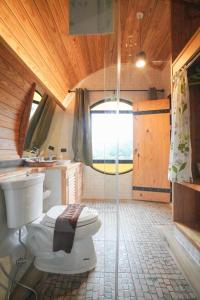 a bathroom with a toilet and a shower at Kiri Pura Resort in Khao Kho