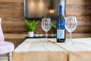 a bottle of wine sitting on a table with two wine glasses at Way2Stay Apartment in Toruń +21 photos