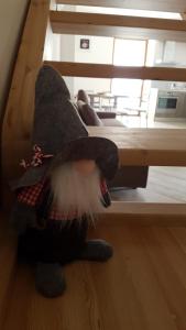 a stuffed cat with a hat sitting on the floor at Appartamento Morettina con terrazzo in Levico Terme