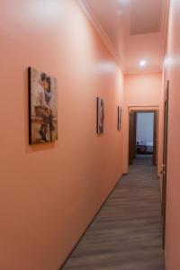 a hallway in a building with paintings on the walls at Re-Ka Luxury Apartments in Odesa