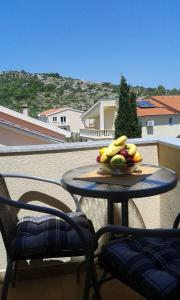 a bowl of fruit on a table on a balcony at Apartments Mara in Drage
