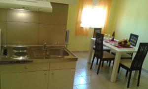 cocina con fregadero y mesa con sillas en Apartments Mara, en Drage