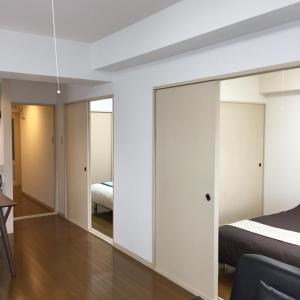 a bedroom with sliding glass doors and a bed at PEARL KAMINOBORI F Plus in Hiroshima