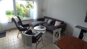 a living room with a couch and chairs and a table at plattedijk 25-47 in Lemmer