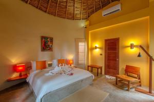 a bedroom with a large white bed in a room at Secret Garden Beach Resort in Bangrak Beach