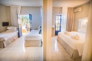 een slaapkamer met 2 bedden en een kamer met een raam bij Parthenis Hotel & Suites in Malia
