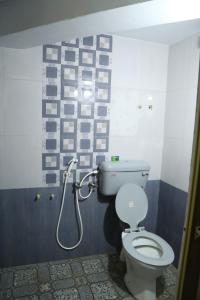 a bathroom with a toilet and a shower at Ranga Residency in Mayiladuthurai
