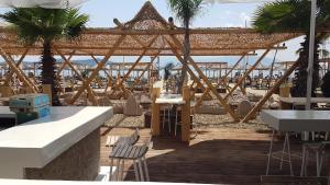 a restaurant with a view of the beach and a bar at Zak Apartments in Keramoti