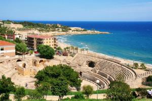an amphitheater next to the ocean on a beach at Vive Tarragona in Tarragona