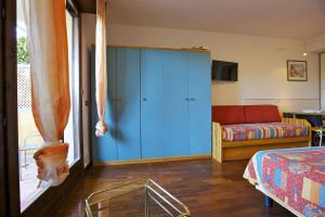 a bedroom with a blue cabinet and a couch at Residenza Moncucco in Luino