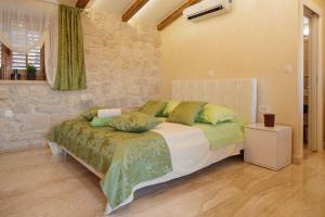 a bedroom with a large bed with green pillows at Luxury View Marjan in Split